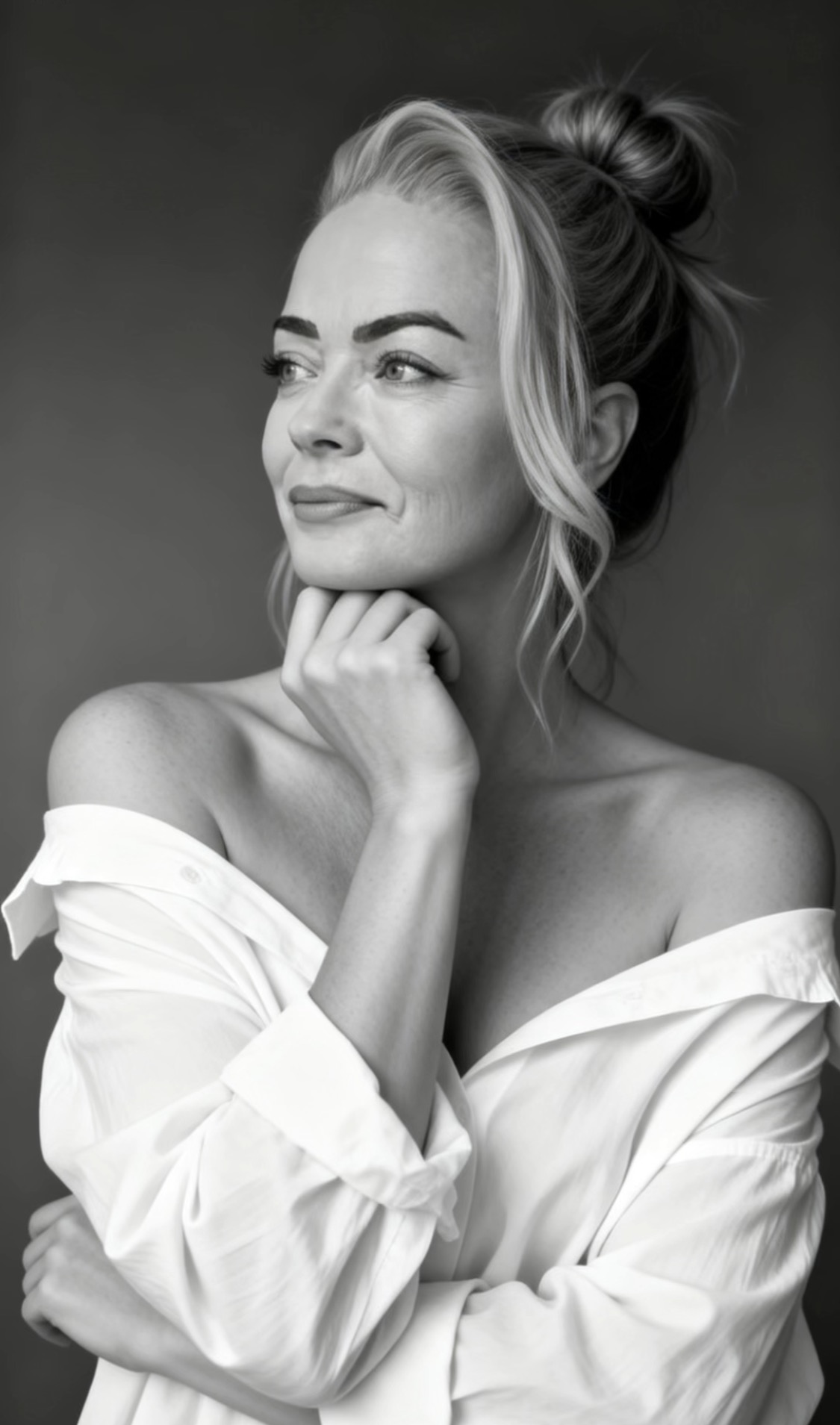 Black-and-white studio portrait of Sandy Kamper with her hand beneath her chin